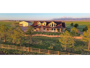 A charming two-story home has a great lawn and a mountain view at 4075 Merada Ct, Franktown, CO 80116