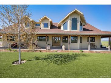 Stunning two-story home featuring a well manicured lawn and a welcoming front porch at 4075 Merada Ct, Franktown, CO 80116