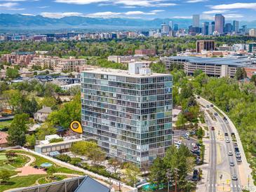 Stunning aerial view of high-rise condo building with panoramic city and mountain views at 3100 E Cherry Creek South Dr # 404, Denver, CO 80209