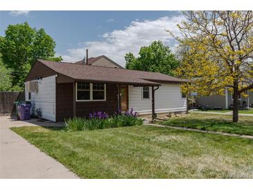Charming single-story home with a well-maintained lawn and colorful landscaping at 1540 S Knox Ct, Denver, CO 80219