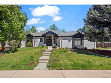 Charming single-story home with well-manicured lawn, lovely landscaping, and welcoming entry at 5302 Pinehurst Dr, Boulder, CO 80301