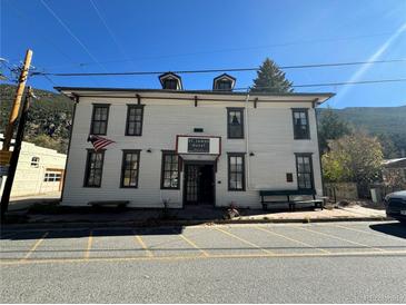Charming multi-story exterior with classic architectural details and a welcoming entrance with benches at 614 Rose St, Georgetown, CO 80444