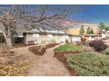 Charming home with well-maintained front yard, landscaping, and a welcoming entrance at 7727 W 81St Pl, Arvada, CO 80005