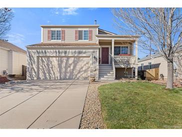 Charming two-story home with a two-car garage, inviting porch, and well-maintained landscaping at 20466 Willowbend Ln, Parker, CO 80138