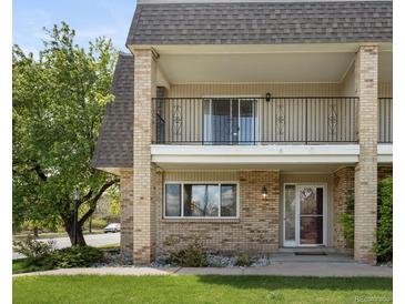 Charming two-story condo with brick facade and a covered balcony, perfect for outdoor relaxation at 6711 S Race St, Centennial, CO 80122
