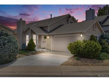 Charming home exterior featuring a two-car garage and well-manicured landscaping at 10436 W 84Th Pl, Arvada, CO 80005