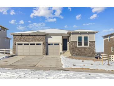 Two-story house with a two-car garage and stone accents at 5091 Hickory Oaks St, Castle Rock, CO 80104