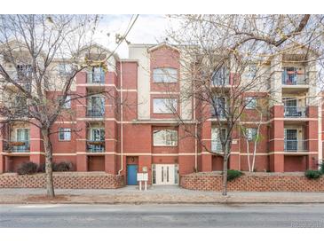 Charming brick apartment building featuring private balconies, manicured lawns, and convenient street parking at 1415 N Washington St # 303, Denver, CO 80203