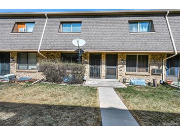 Brick townhome featuring a mature bush and pathway to the front door at 1791 Quail St, Lakewood, CO 80215