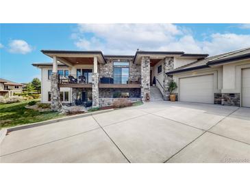 Stunning stone-accented home with a large driveway, inviting outdoor spaces, and a spacious two-car garage at 11194 W Yucca, Littleton, CO 80125