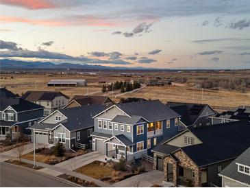 Stunning aerial view of a residential neighborhood with mountain views at sunset at 7895 Julsburg Cir, Littleton, CO 80125
