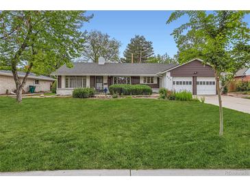 Charming home with manicured lawn, mature trees, and a two-car garage at 502 Nile St, Aurora, CO 80010