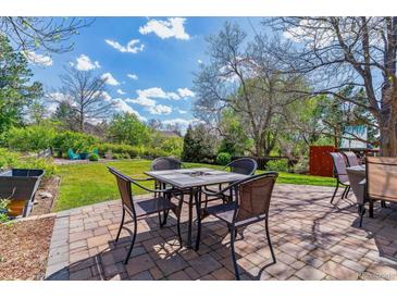 Paver patio with outdoor seating and lush backyard, perfect for entertaining guests in the beautiful outdoor space at 6918 E Easter Pl, Centennial, CO 80112