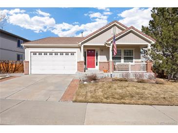 Charming single-Gathering home with a red front door, attached garage, and well-maintained front yard at 2085 Cactus Bloom Ct, Castle Rock, CO 80109