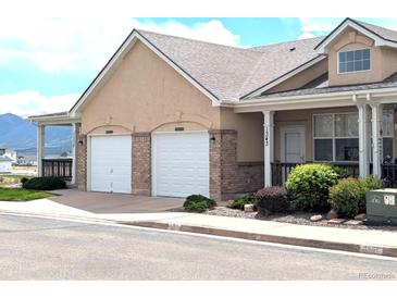 Charming home featuring a two-car garage, inviting front porch, and well-maintained landscaping at 1343 Villa Grv, Monument, CO 80132