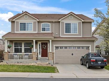 Charming two-story home featuring a covered front porch, well-maintained landscaping, and attached two car garage at 2468 Candleglow St, Castle Rock, CO 80109