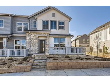 Charming townhome featuring a stone facade and inviting front porch, perfect for enjoying the neighborhood views at 1961 S Haleyville Way, Aurora, CO 80018