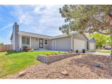 Charming single Gathering home with manicured lawn, beautiful flower beds, and a two car garage at 4182 S Joplin St, Aurora, CO 80013
