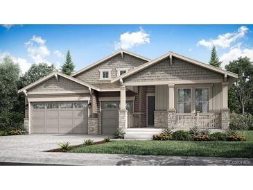 Inviting single-story home featuring a charming front porch, stone accents, and a two-car garage at 3967 Descent St, Castle Rock, CO 80108