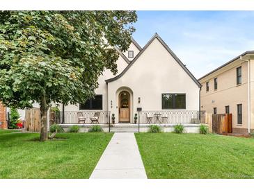 Charming home featuring a well-manicured lawn, a walkway, and a decorative fence with outdoor seating at 659 Albion St, Denver, CO 80220
