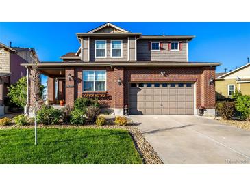 Beautiful two-story home featuring a brick facade, attached garage, and well-manicured lawn at 27029 E Irish Pl, Aurora, CO 80016