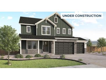 Charming two-story home with a three-car garage, stone accents, and a well-manicured lawn at 470 Clear Bell Ln, Monument, CO 80132