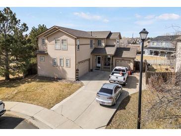 Charming two-story home with a long driveway and attached two-car garage, great for suburban living at 3699 S Killarney St, Aurora, CO 80013