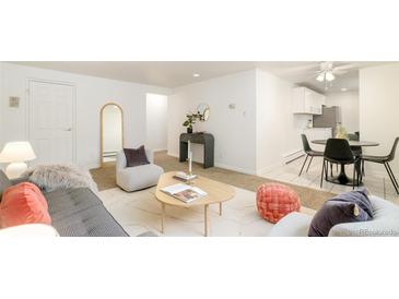 Bright living room featuring neutral colors, stylish furnishings, and an open layout leading into the kitchen at 1243 N Washington St # 108, Denver, CO 80203