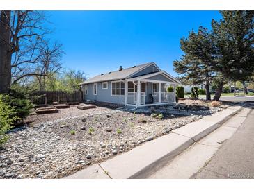 Charming home with a welcoming front porch, rock garden, and blue skies at 4196 S Pennsylvania St, Englewood, CO 80113