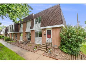 Two-story brick townhouse with flower bed in front at 12956 W Virginia Ave, Lakewood, CO 80228