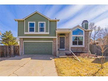 Charming two-story home with an attached two-car garage, a stone facade, and mature landscaping at 616 N Brentwood Ct, Castle Rock, CO 80104