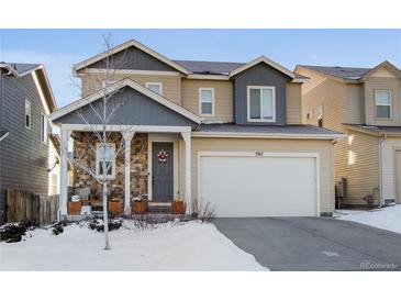 Two-story house with attached garage, stone accents, and a welcoming front porch at 3912 Trail Stone Cir, Castle Rock, CO 80108