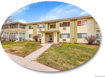 A two-story apartment complex featuring well-kept landscaping, a charming walkway, and a welcoming facade at 725 S Clinton St # 1B, Denver, CO 80247