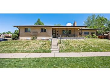 Charming brick home with a covered front porch and well-maintained front yard at 2501 E Arkansas Ave, Denver, CO 80210