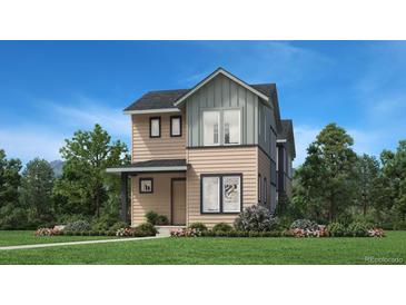 Charming two-story home featuring a manicured lawn, well-placed shrubbery and a covered porch, perfect for curb appeal at 858 Promenade Dr, Superior, CO 80027
