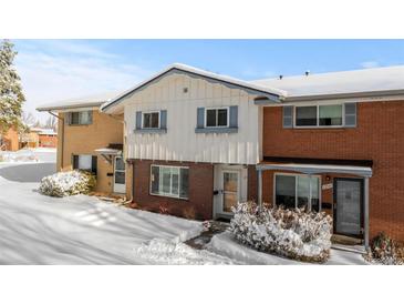 Inviting townhome featuring a charming facade and snow-covered landscaping at 12543 W Alameda Dr, Lakewood, CO 80228