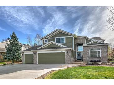 Inviting two-story home with a three-car garage and beautiful brick and siding accents at 10824 Quail Ridge Dr, Parker, CO 80138
