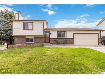 Charming two-story home featuring a well-manicured front lawn and attached two car garage at 10550 Routt St, Westminster, CO 80021