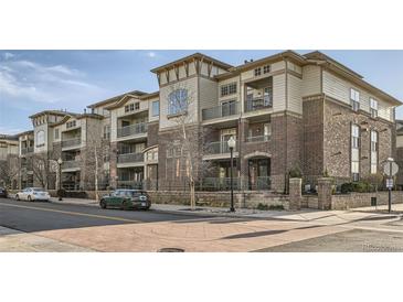 Modern condo building featuring brick accents, multiple stories, and private balconies at 3872 S Dallas St # 7-307, Aurora, CO 80014