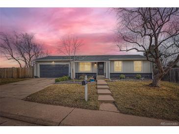 Charming single-story home featuring a well-manicured front yard and an attached garage, perfect for suburban living at 15756 E Temple Pl, Aurora, CO 80015