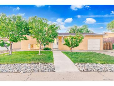 Charming ranch home featuring mature trees, a well-manicured lawn, and inviting curb appeal at 14595 Robins Dr, Denver, CO 80239