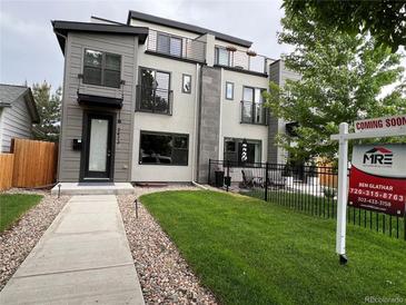 Contemporary home with gray siding, black accents, small balconies, and a well-maintained front lawn at 2473 S Cherokee St, Denver, CO 80223
