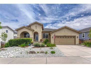 Charming stucco home with beautiful landscaping, rock features, and an attached two-car garage at 2868 Breezy Ln, Castle Rock, CO 80109