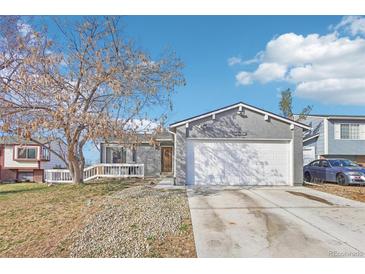 Charming single-Gathering home featuring a two-car garage and inviting front porch at 19003 E Oxford Dr, Aurora, CO 80013