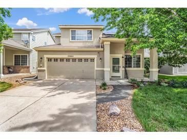 Charming two-story home featuring a two-car garage and a beautifully landscaped front yard at 19463 E Hollow Creek Dr, Parker, CO 80134