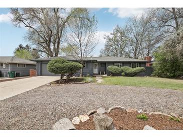 Charming ranch-style home featuring a well-maintained yard and mature trees, creating a welcoming curb appeal at 3179 S University Blvd, Englewood, CO 80113