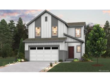 Charming two-story home showcasing modern design, a two-car garage, and inviting curb appeal at 19039 E 94Th Pl, Commerce City, CO 80022