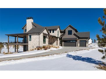 Stunning two-story home with stone accents and a covered porch at 2442 Fox View Trl, Franktown, CO 80116
