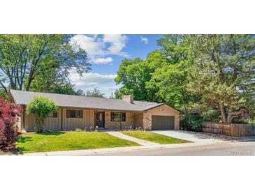 Charming single-story home with a lush green lawn and mature trees at 6330 E Vassar Ave, Denver, CO 80222