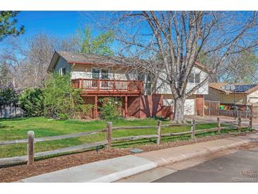 Charming home featuring a spacious deck and well-maintained front yard at 7065 S Willow St, Centennial, CO 80112